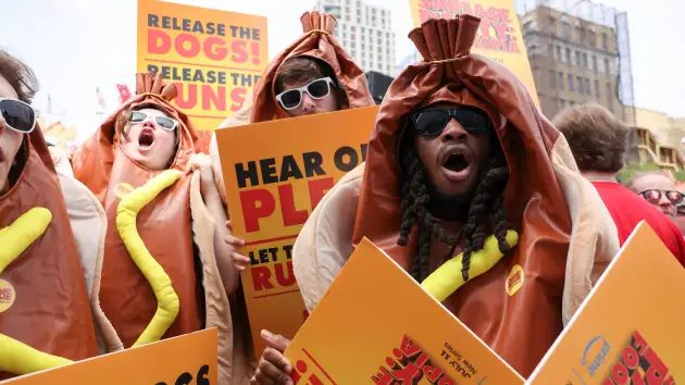 People wear hot dog outfits, as they attend the 2024 Nathan’s Famous Fourth of July International Hot Dog Eating Contest, at Coney Island, in New York City, U.S., July 4, 2024Kent J. Edwards | Reuters