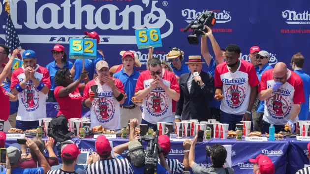 Patrick Bertoletti, Geoffrey Esper and other contestants compete in the 2024 Nathan’s Famous Fourth of July International Hot Dog Eating Contest at Coney Island in New York City, U.S., July 4, 2024.Jeenah Moon | Reuters